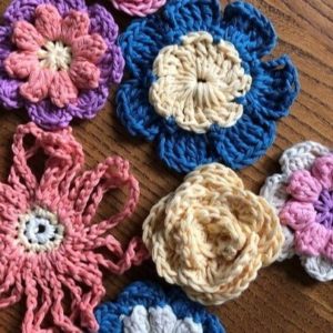 crochet flowers in blue pink and yellow