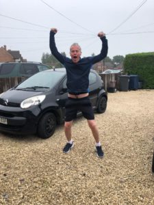 Man jumping up, holding his hands in the air in celebration