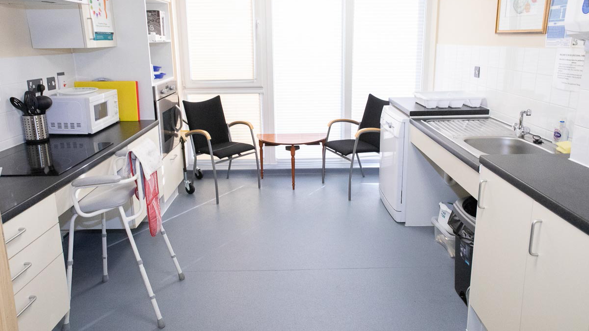 Small kitchen containing assistive devices.