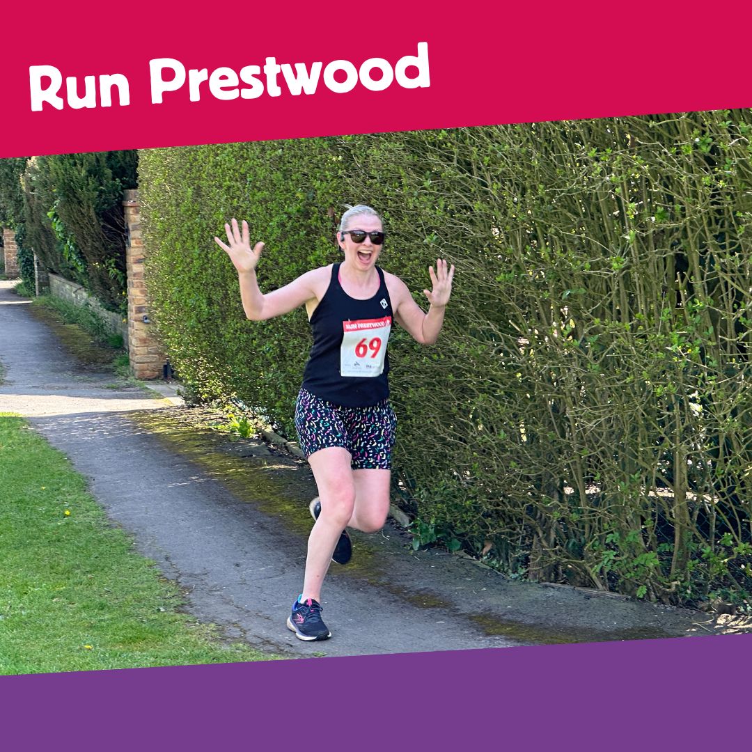 Runner taking part in a race. She is holding her hands in the air and smiling. There is a pink banner above the image with text saying run prestwood and a purple banner below.