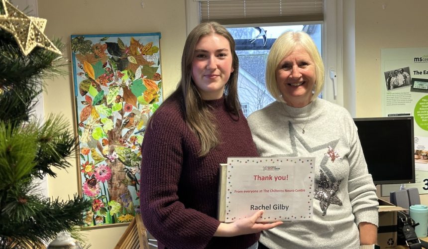 Rachel Gilby being presented her Volunteer Award certificate by Cathy Garner.